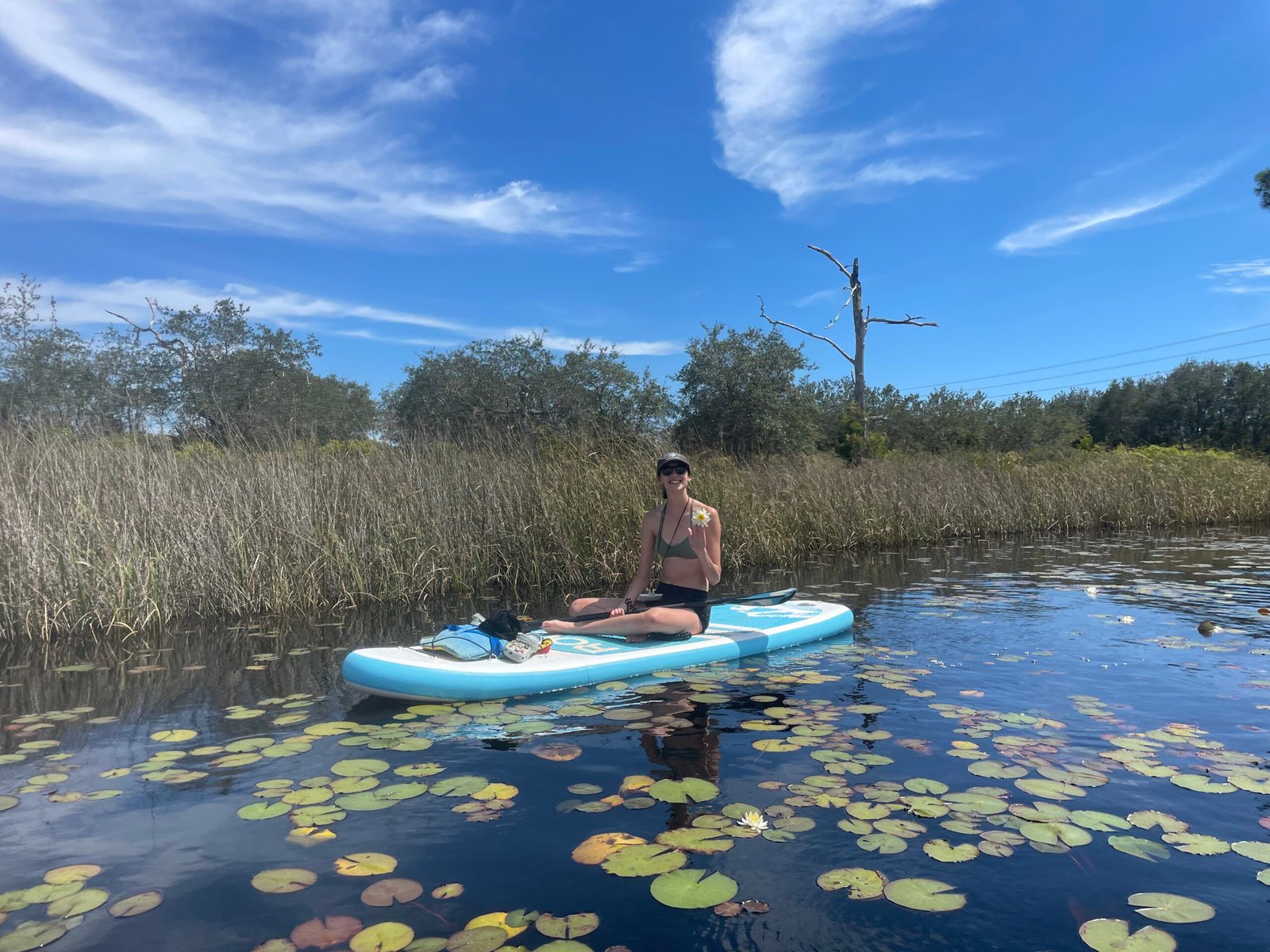 Paddleboarder on a coastal dune lake at Grayton Beach State Park