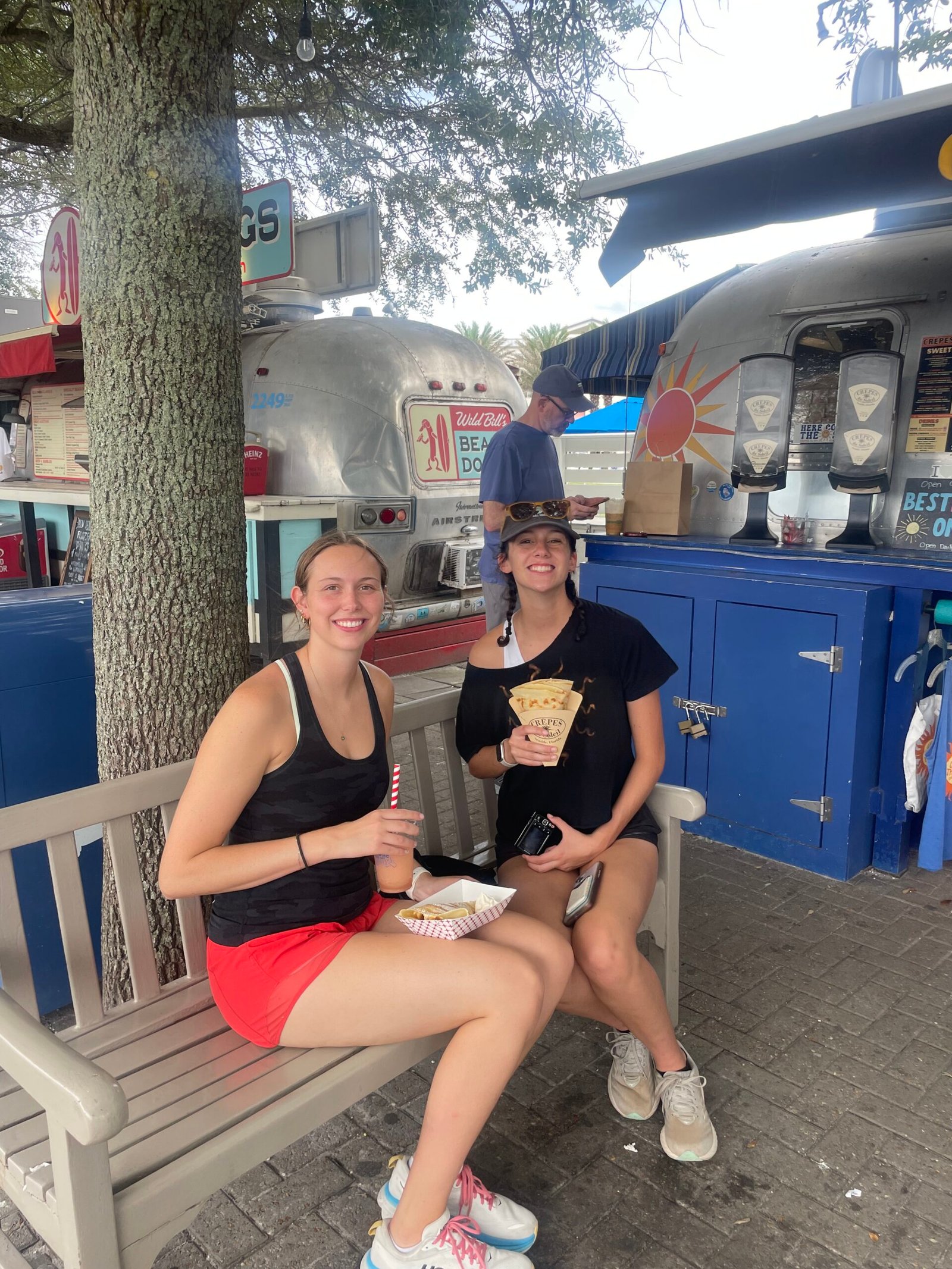 Family enjoying crepes near the Airstream food trucks in Seaside