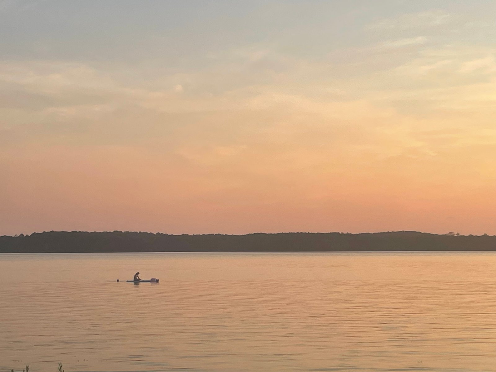 Paddleboard on the shore at sunset beside Lake Juliette
