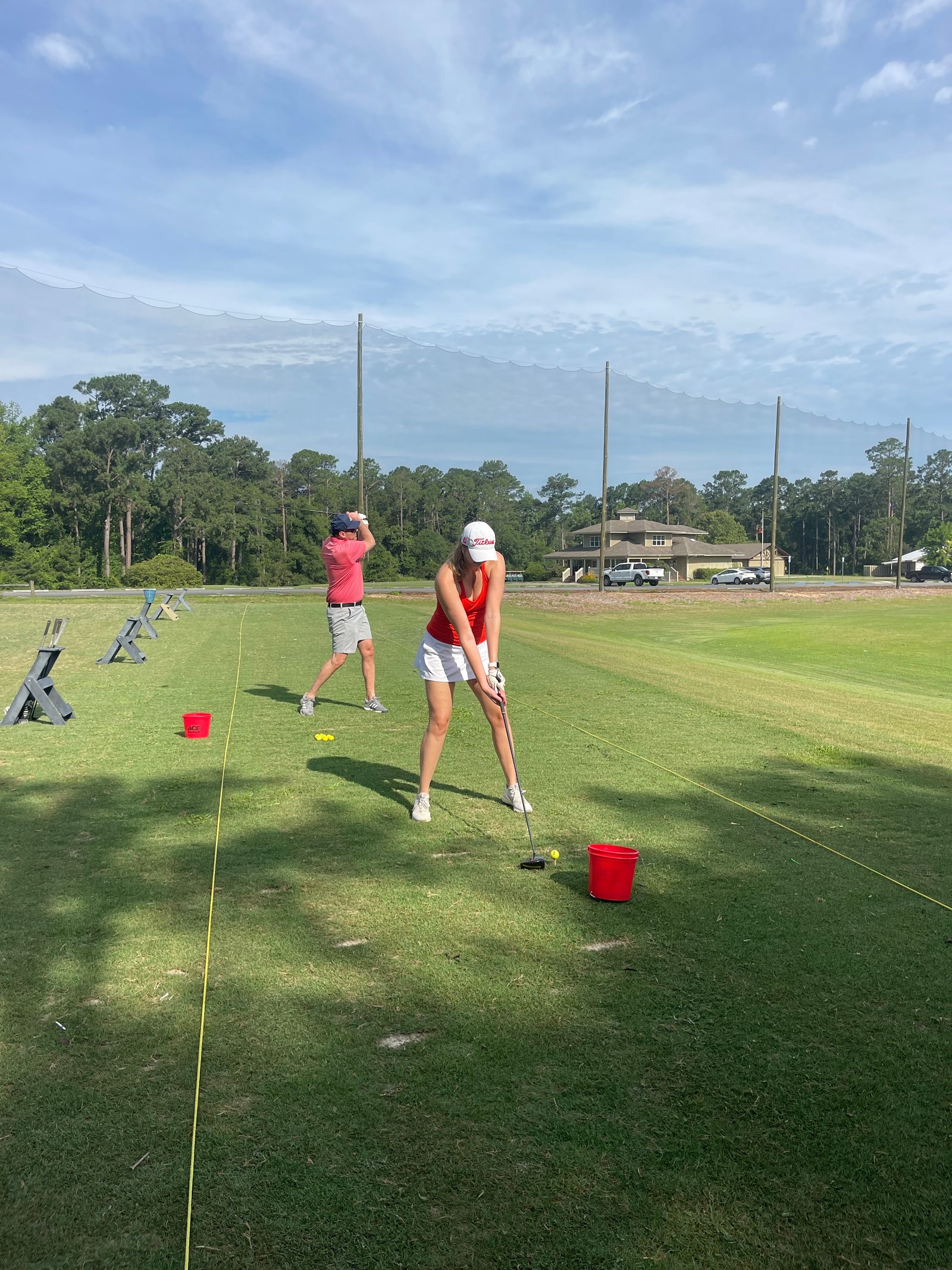 Golfers warming up at the Brazell's Creek Golf Course driving range